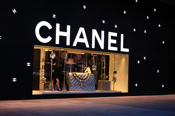 Illuminated storefront channel letter sign at night