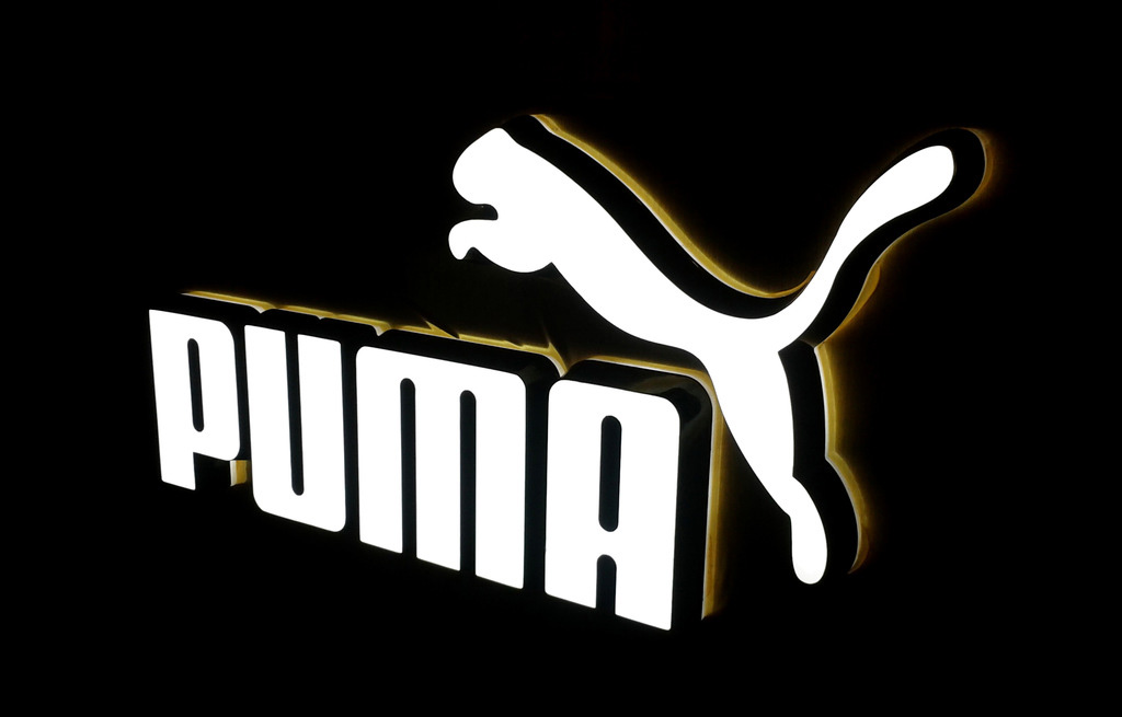 Illuminated neon-style brand logo sign